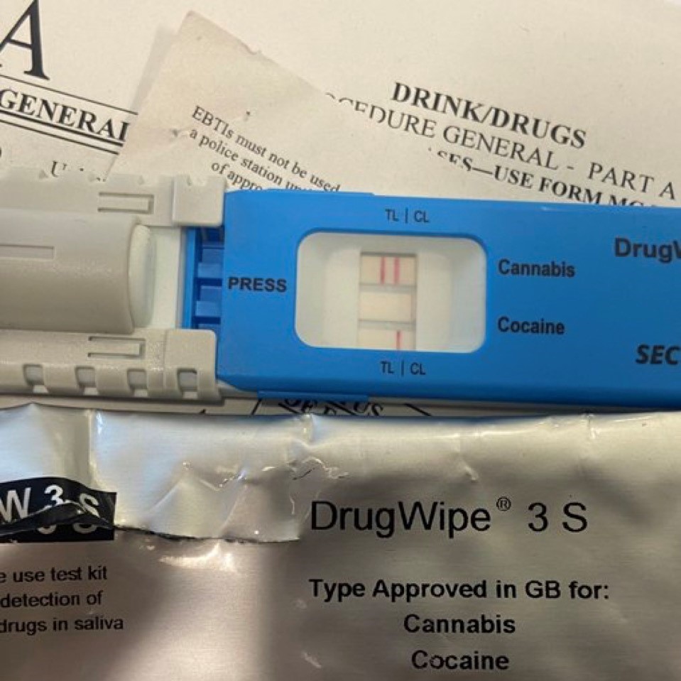 A plastic drug wipe sat on top of drug driving paperwork