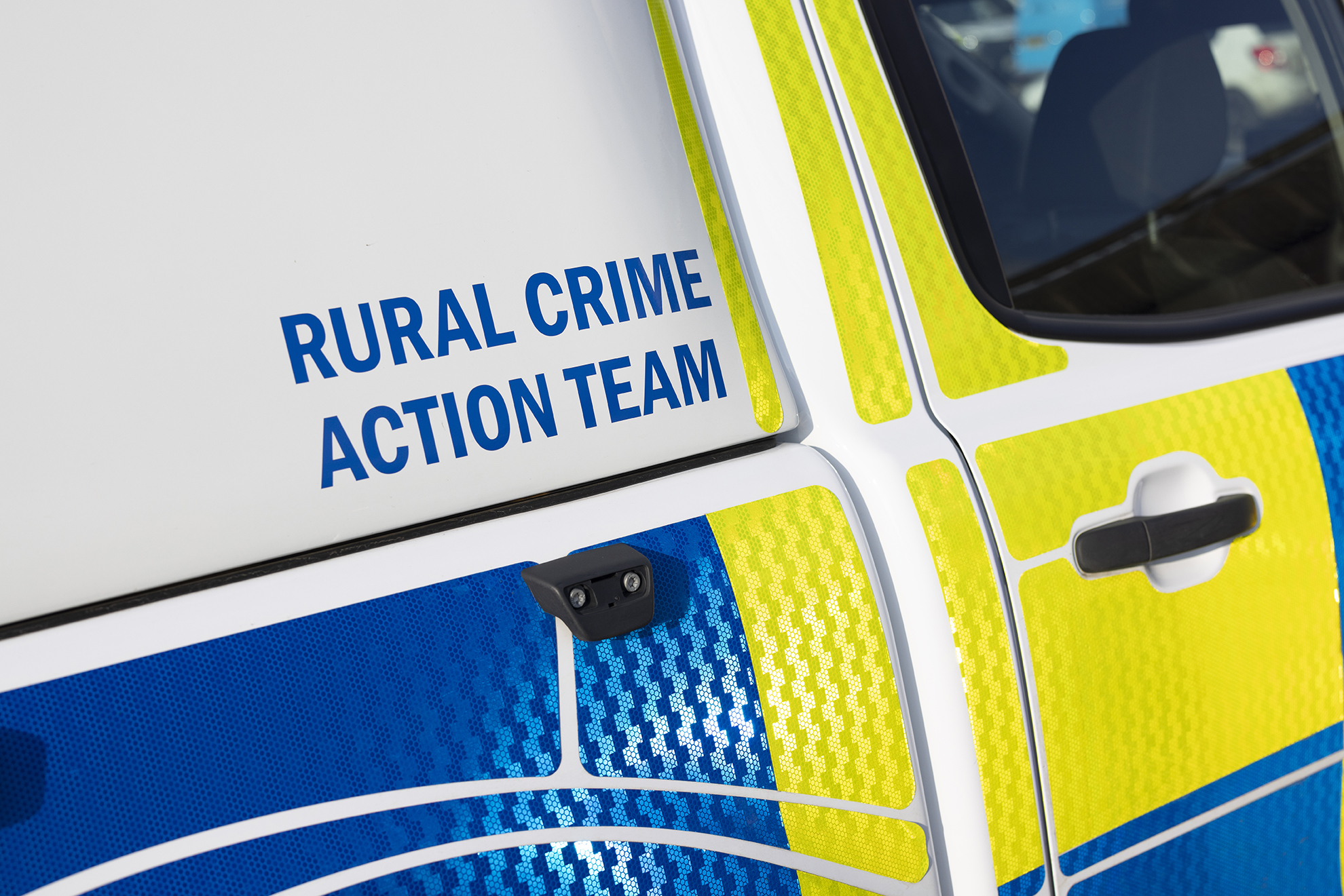 An image of a police car with the word 'RURAL CRIME ACTION TEAM' in blue lettering on a white background