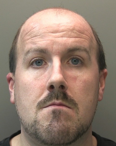 man with mid-brown receding hair and facial hair