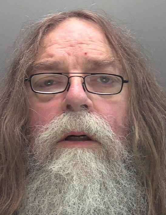 Man with long brown hair and grey beard, wearing glasses