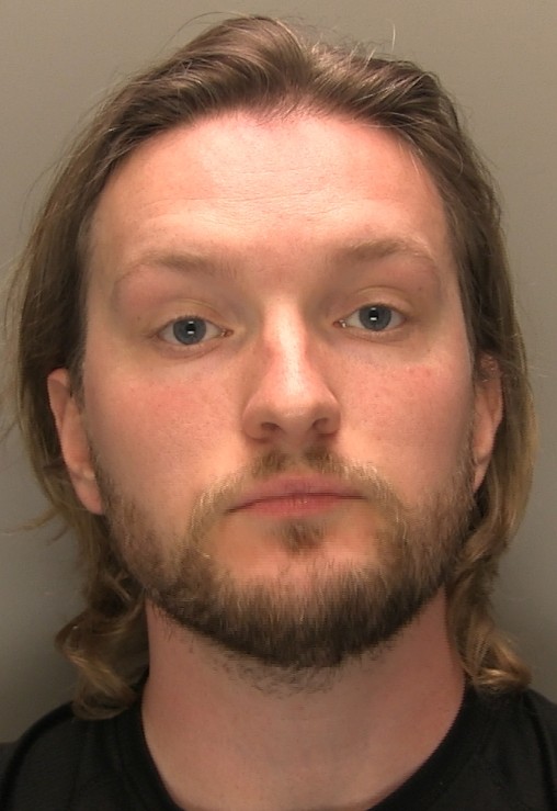 Man with shoulder-length mid-brown hair and facial hair