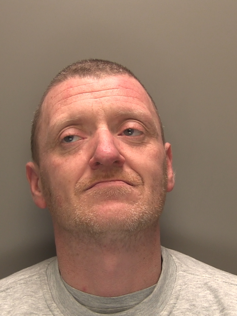 Patrick Joseph Wiggins is wearing a grey top and is looking away from the camera.