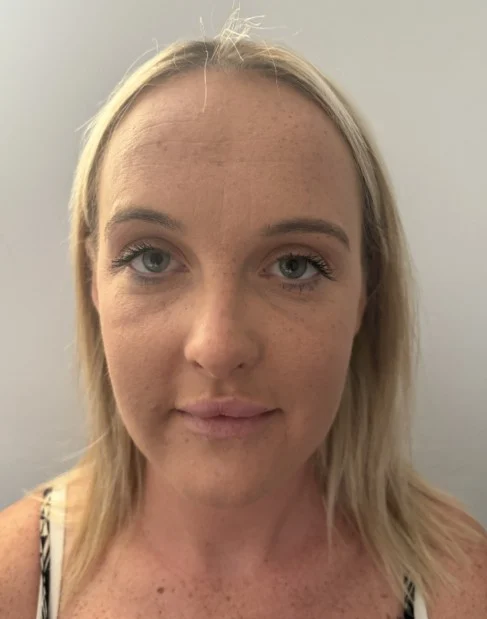Woman with blonde hair, grey/blue eyes and light freckles 