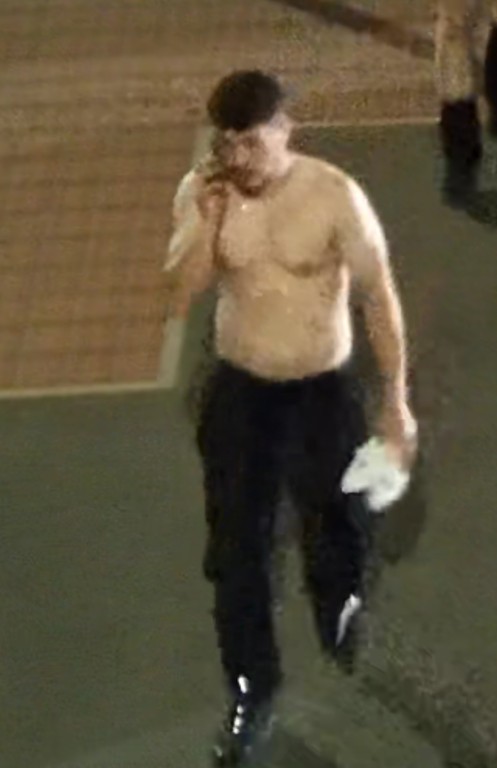 CCTV image of man we'd like to speak to in connection with the assault. He is wearing black joggers and is holding a white t-shirt. 