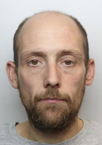 Man with mid-brown receding hair and facial hair