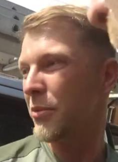 Man with blond hair with fringe, light goatee, wearing a sage green t-shirt