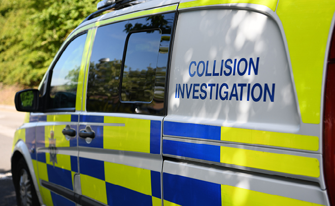 A marked police van with the words collision investigation written along the side.
