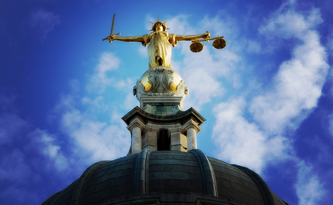 Lady justice statue blue skies and clouds