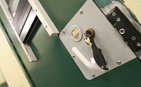 Close up of prison cell door lock and key