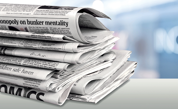 A pile of folded newspapers. 