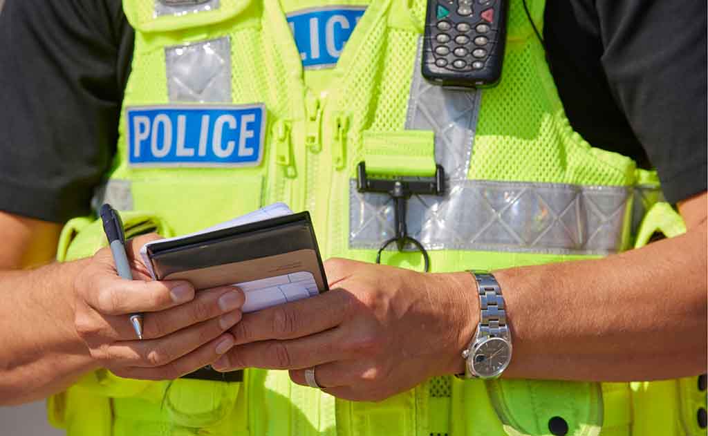 Police officer - with notebook (pocket book - pen - writing)