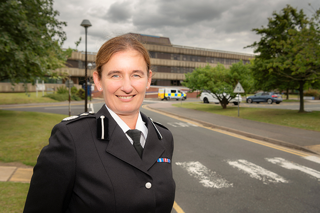 Photo of DCC Debenham, in formal uniform, smiling and looking into the camera.