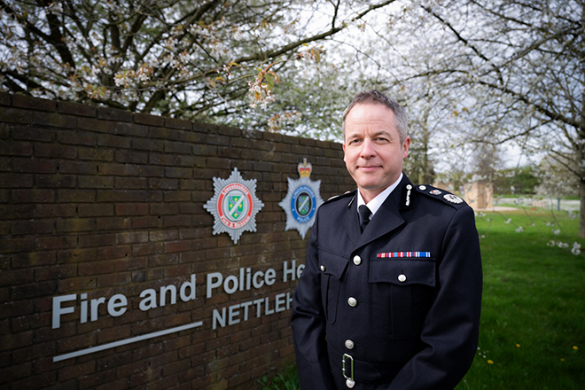 Chief Constable Paul Gibson in uniform standing outside of the joint Police and Fire HQ 